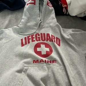 gray lifeguard sweater.